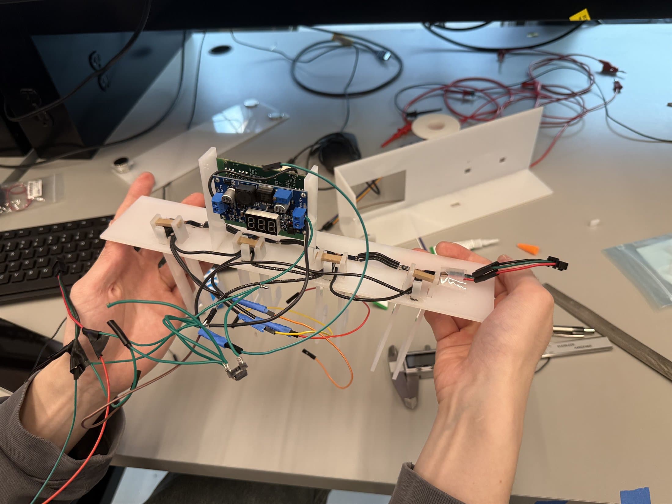 Velo hook base and PCBA photographed from the back during assembly.