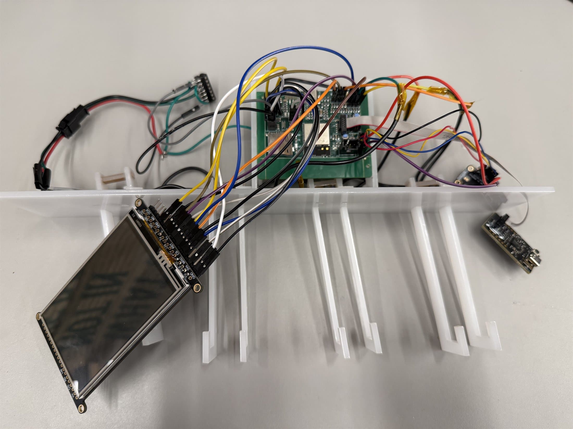 Velo hook base, PCBA, and LCD during final assembly.