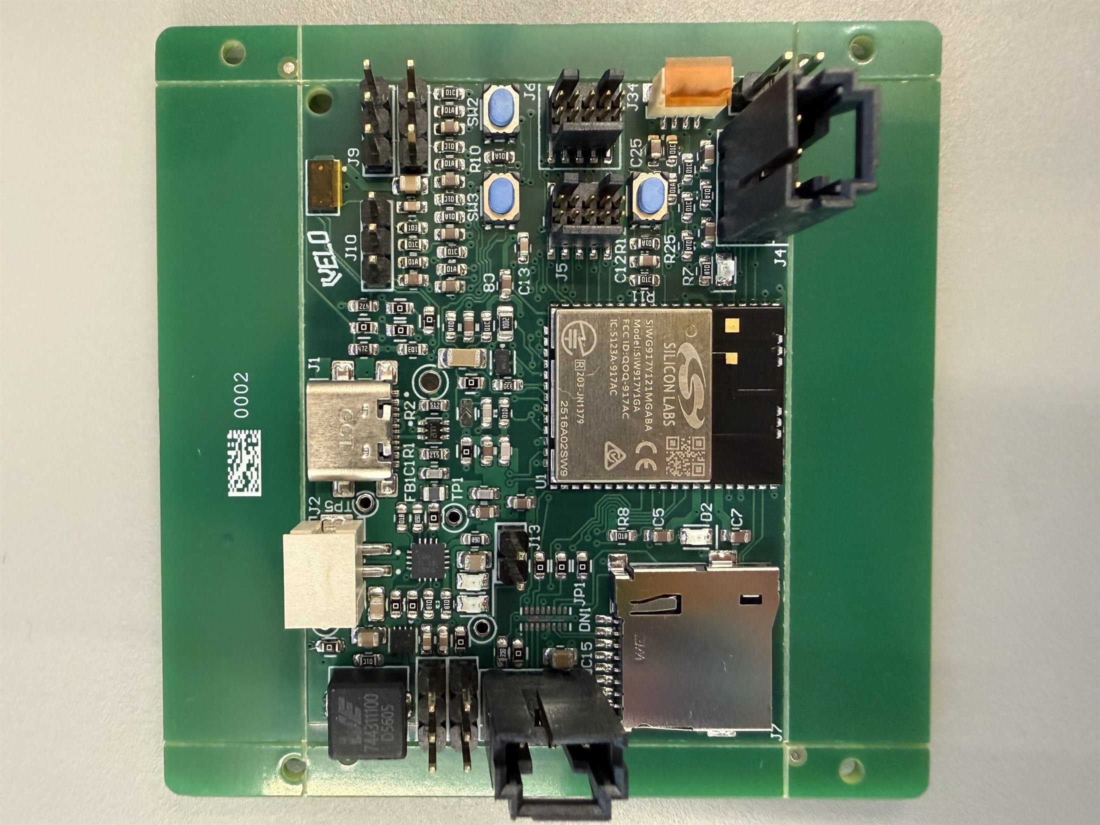 Velo custom PCB photographed on a light background.